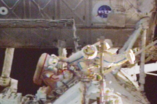 Spacewalkers Gennady Padalka and Mike Fincke work at the Station's S0 Truss to restore power to a Control Moment Gyro.
