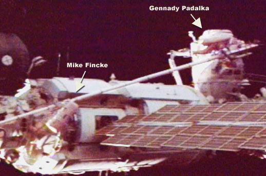 Padalka and Fincke use the Strela crane to move across the Station during a spacewalk.